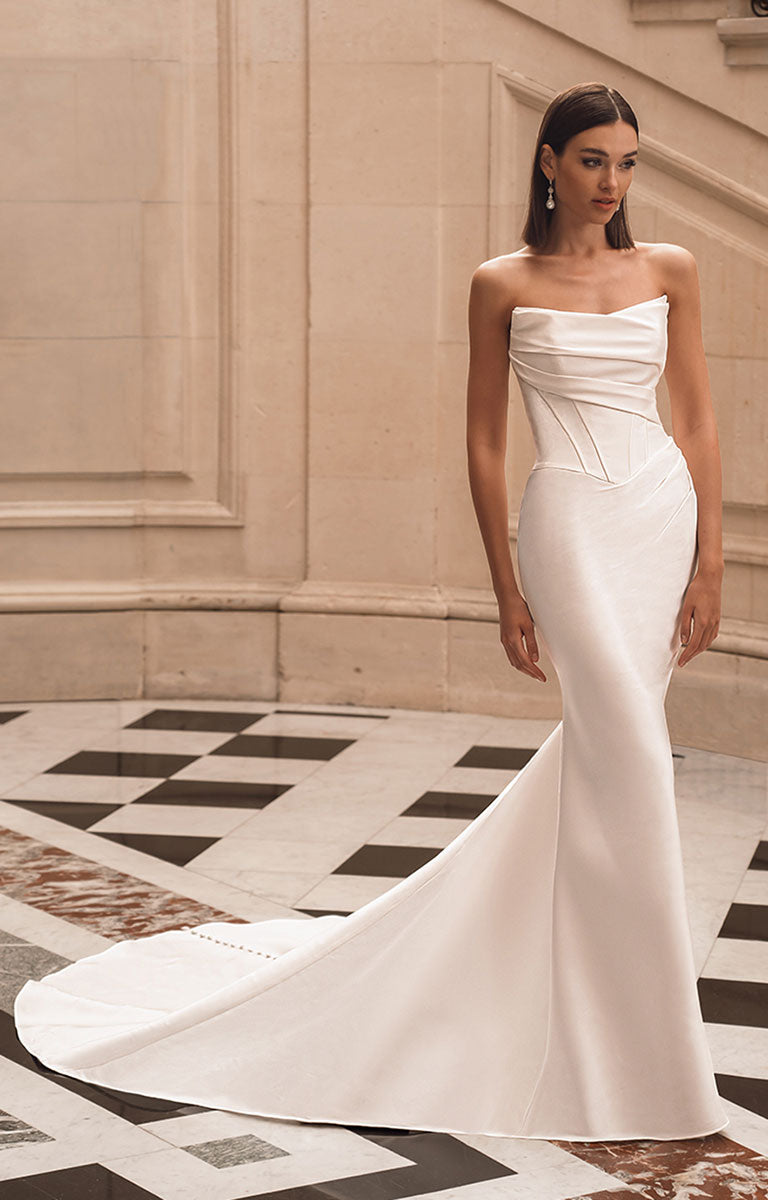 Woman wearing a white strapless gown in an elegant interior setting