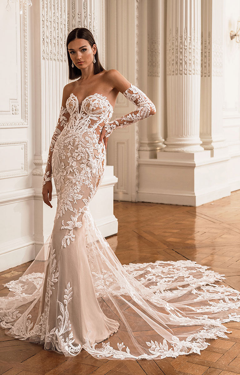 Woman wearing a white lace wedding dress in an elegant interior setting