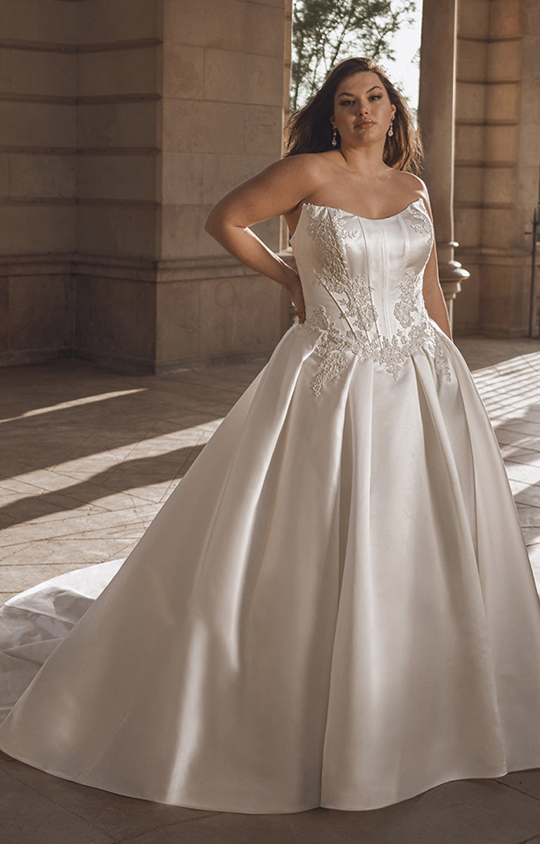 Woman wearing a white wedding dress in an outdoor setting