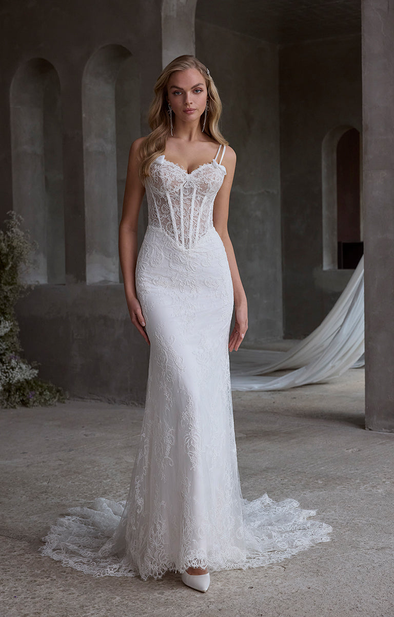 Woman wearing a white lace wedding dress in an architectural setting