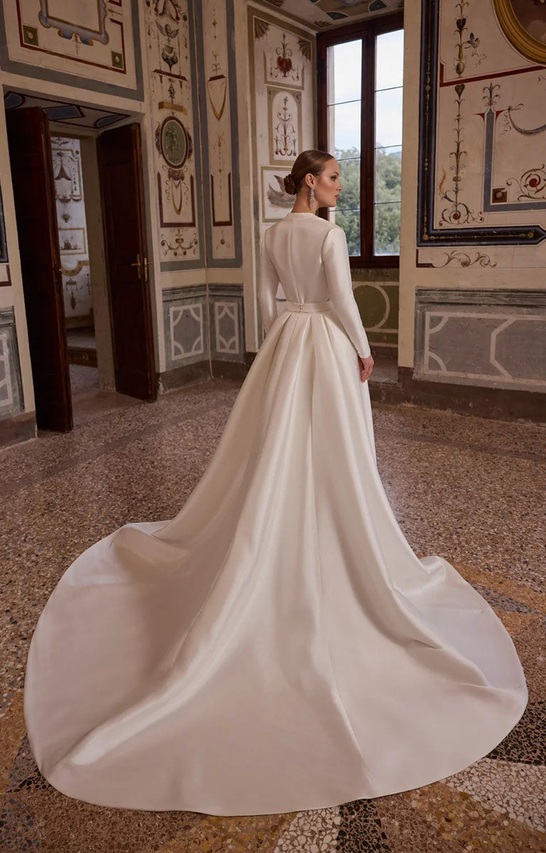 A woman modelling Veni Infantino Algarve 63332 - Fitted Lace Wedding Dress with High Illusion Neckline, Sparkle and Detachable Belt featuring optional Coat 10370