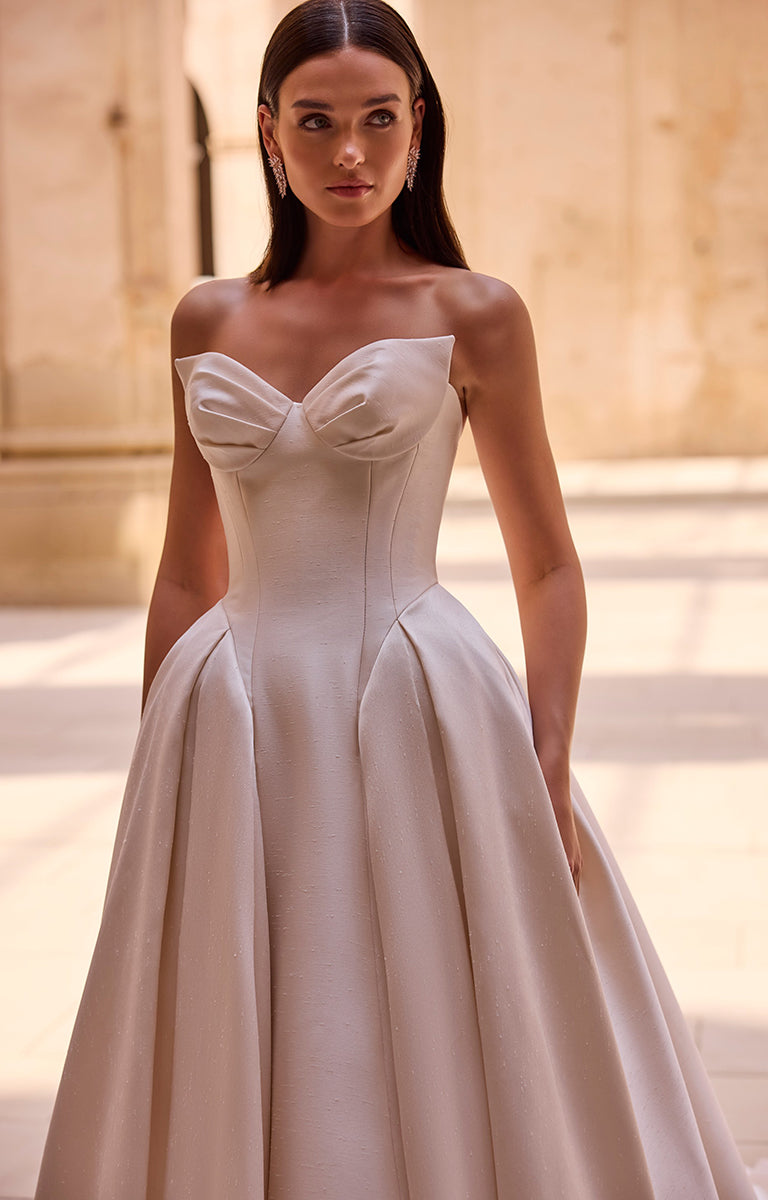 Woman wearing a strapless wedding dress with a soft background