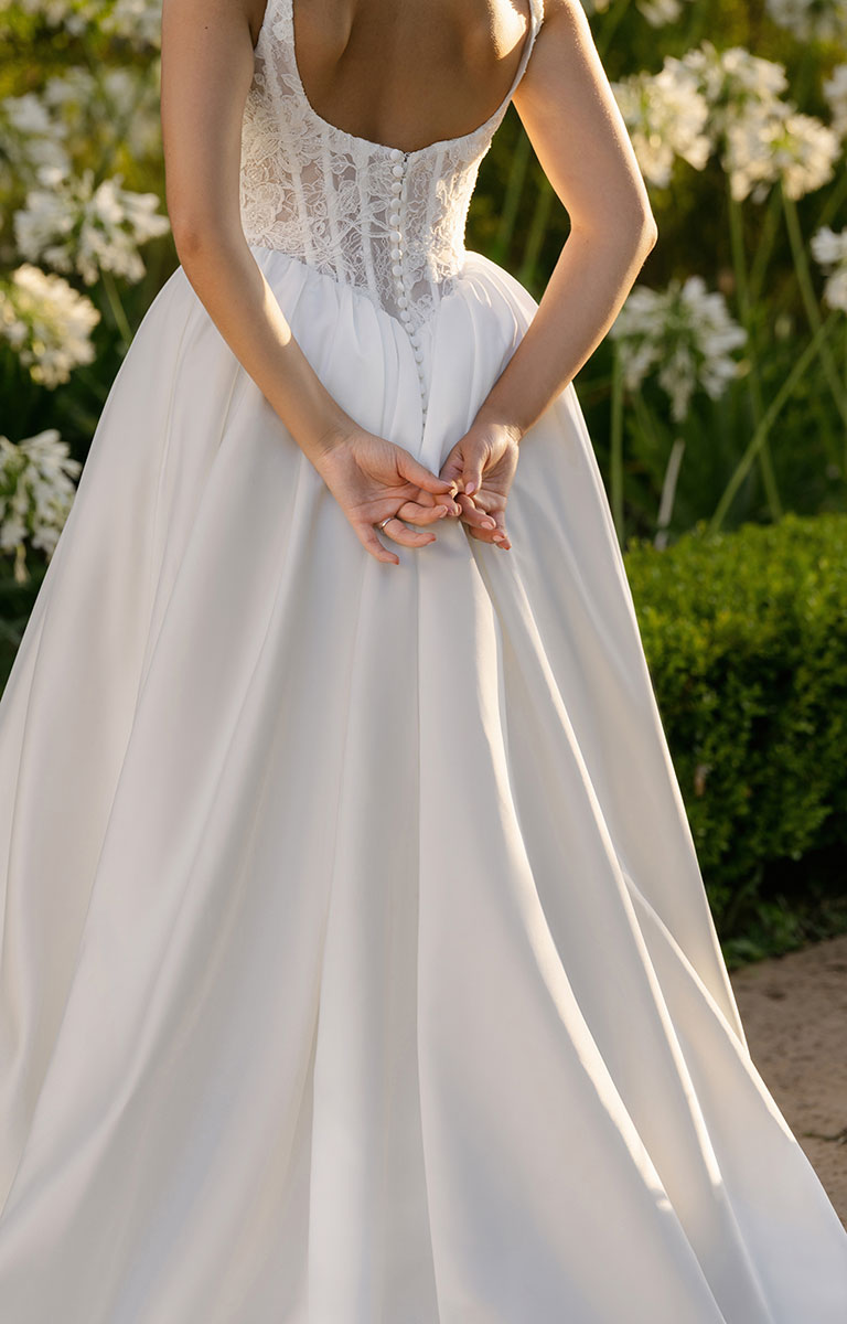A1406 by Allure Bridal from Abella - Beaded Lace and Satin Ball Gown Wedding Dress with lace detailing in a garden setting