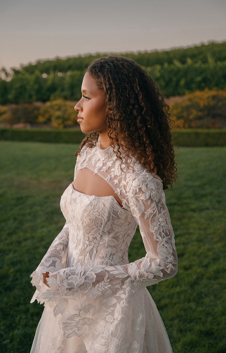 Woman in A1408 by Allure Bridal - Strapless Sequin Lace and Tulle Ball Gown Wedding Dress standing in a vineyard