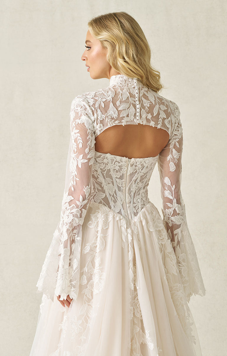 Woman wearing A1408 by Allure Bridal - Strapless Sequin Lace and Tulle Ball Gown Wedding Dress with long sleeves and an open back against a plain background