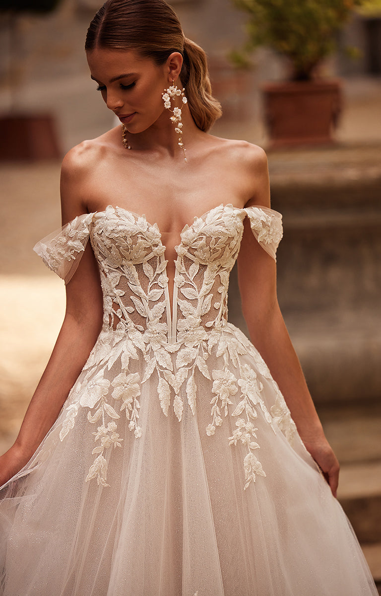 Woman wearing a white lace wedding dress with a blurred background