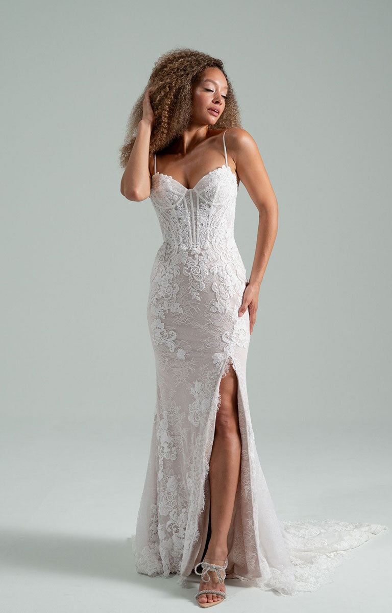Woman wearing Becoming Jane by Hayley Paige - Convertible Lace Fit-and-Flare Wedding Dress with Tulle Overskirt and a  slit on a gray background