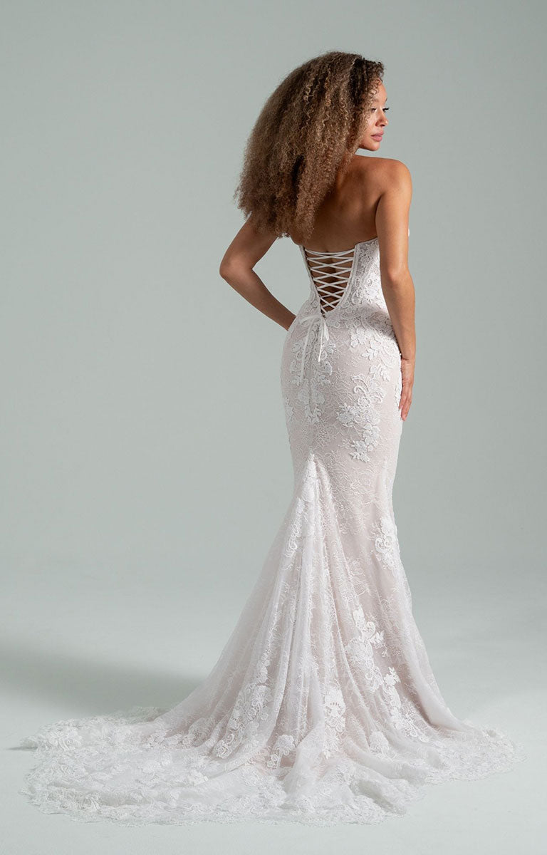 Woman wearing Becoming Jane by Hayley Paige - Convertible Lace Fit-and-Flare Wedding Dress with Tulle Overskirt with a gray background