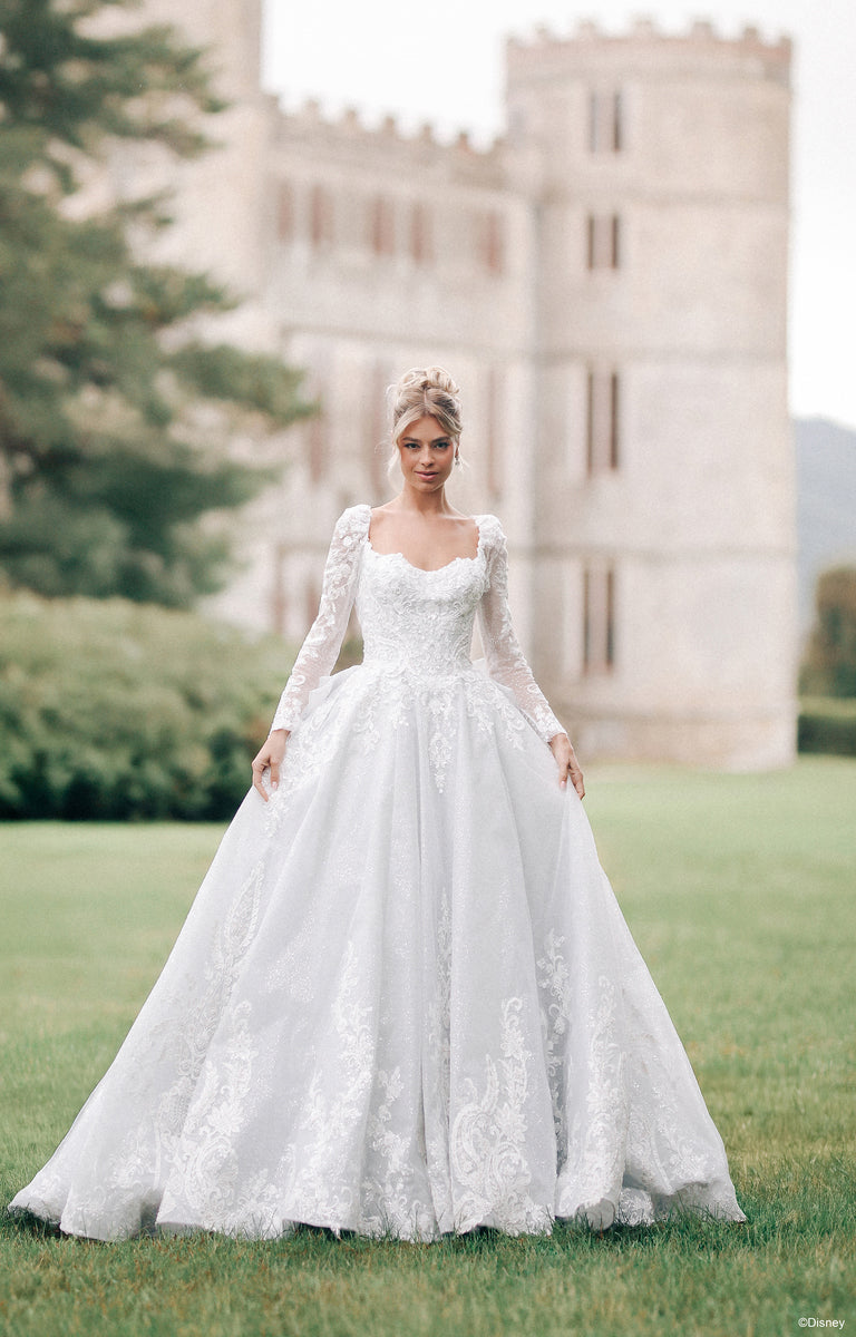 Lady in front of a Castle wearing DP453 Cinderella Wedding Dress from the Disney Fairytale Weddings collection.