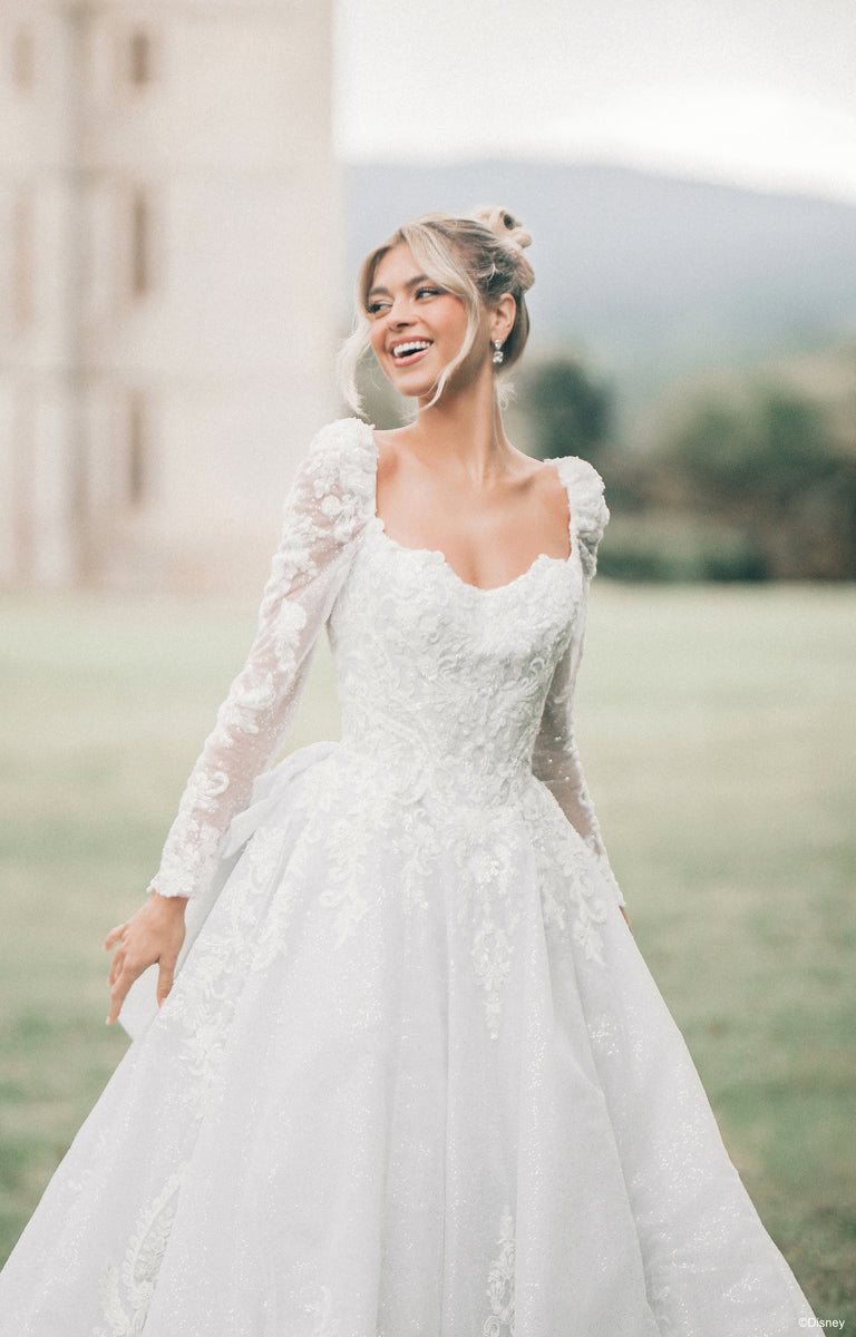 Lady in front of a Castle wearing DP453 Cinderella Wedding Dress from the Disney Fairytale Weddings collection.