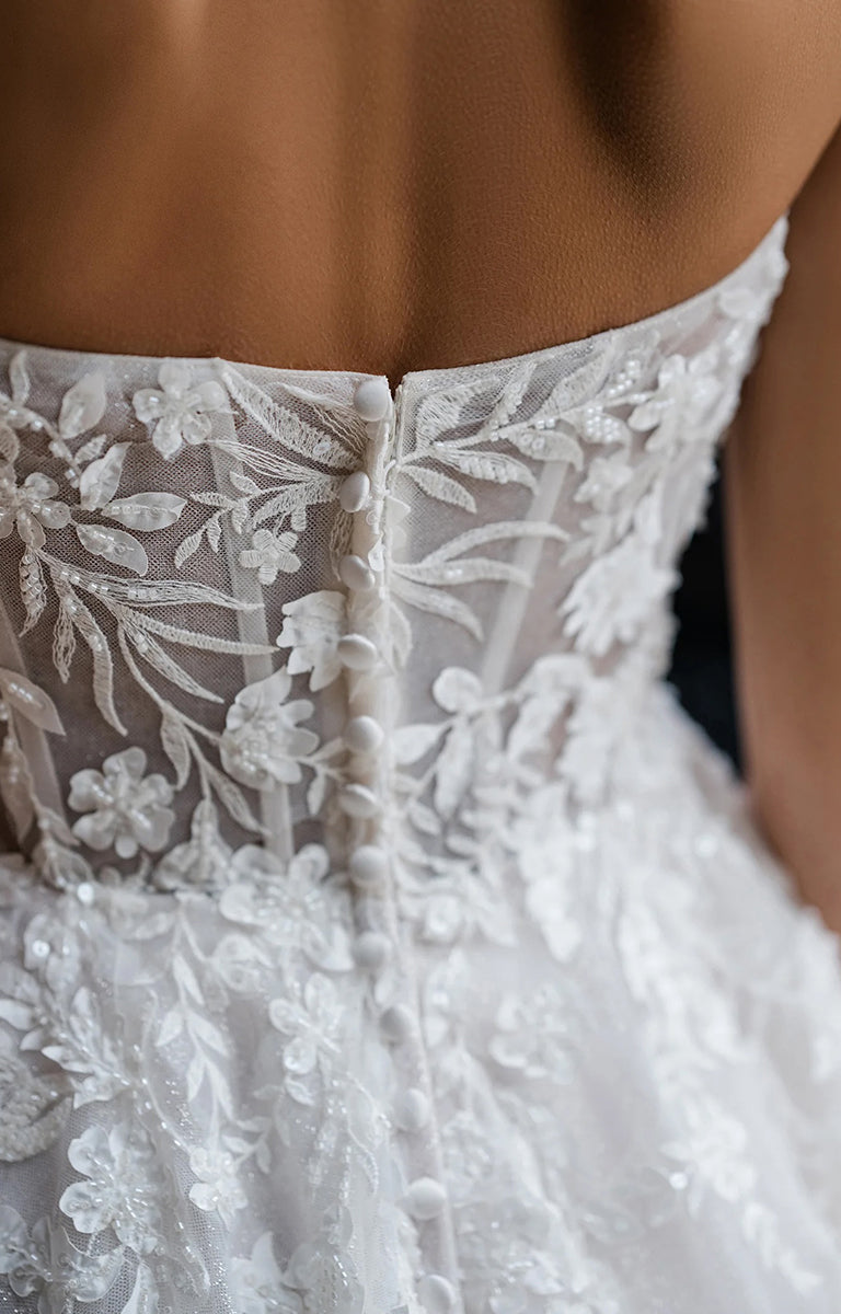 Close-up of Benedita E461 by Abella Bridal - Beaded Lace A-Line Tulle Wedding Dress with floral details.