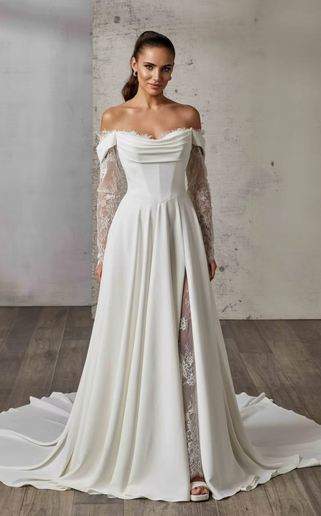 Woman wearing a white off-shoulder wedding dress with a slit on a wooden floor.