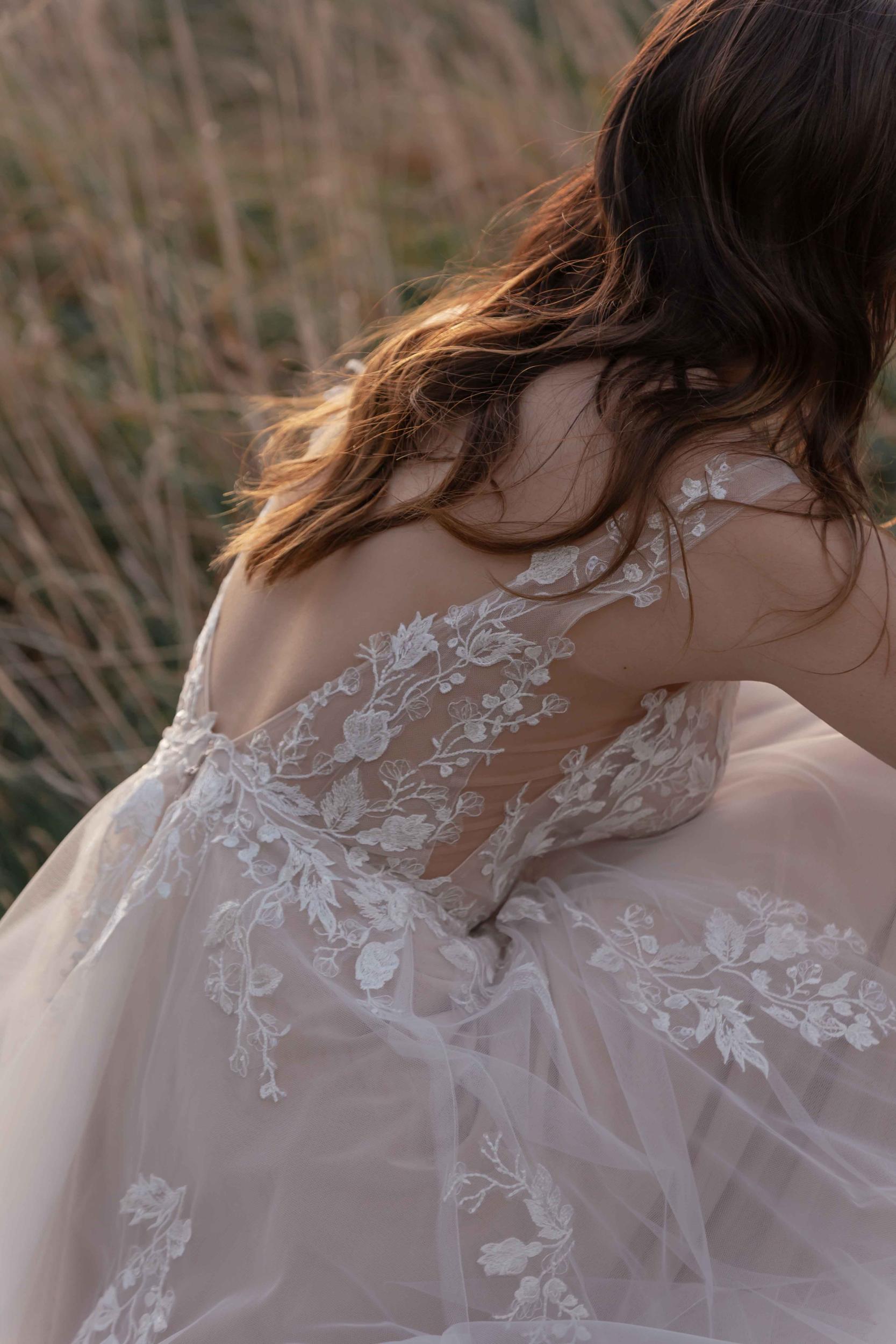 Woman in a lace dress with a blurred natural background