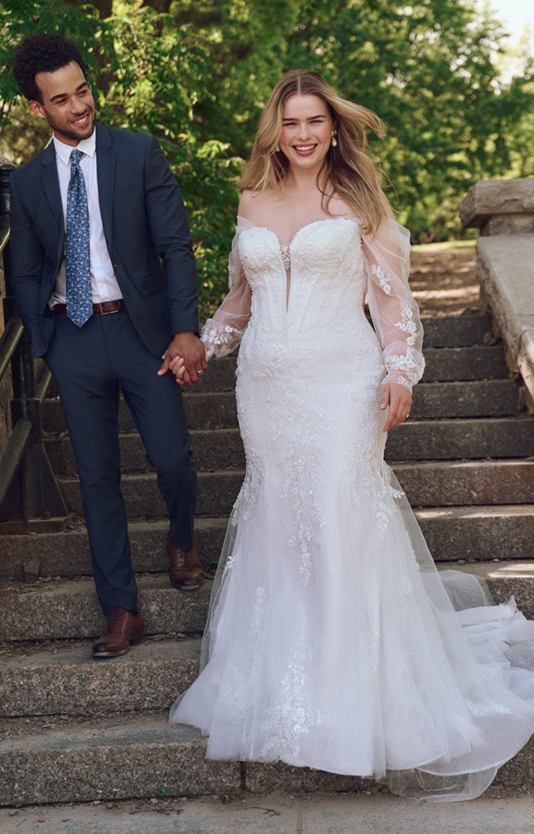 Man and woman holding hands on stone steps outdoors