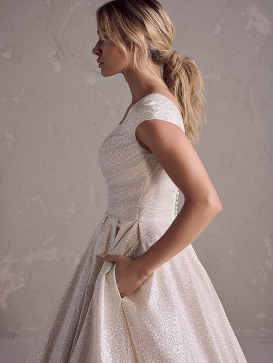 Woman wearing a white lace dress against a neutral background