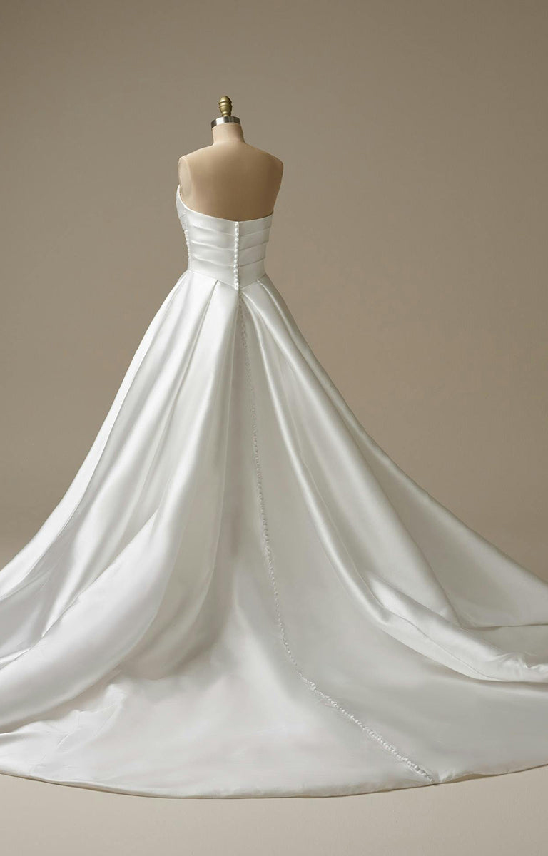 Woman wearing Aubrielle Marie by Maggie Sottero - Reena Mikado Asymmetrical Pleated Ball Gown