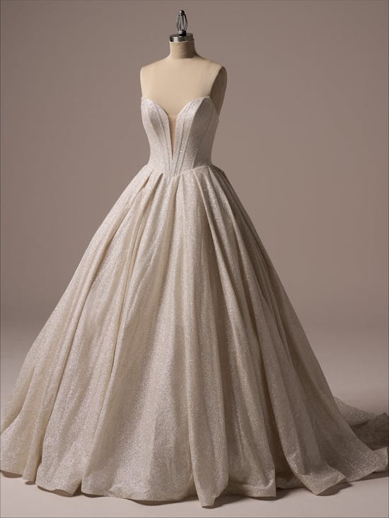Beige wedding dress on a mannequin against a neutral background