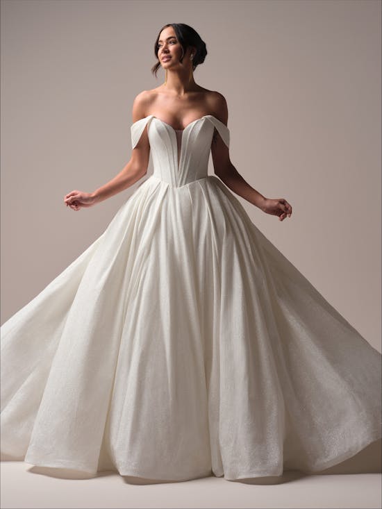 Derrick Royale by Maggie Sottero - Woman wearing a white wedding dress against a plain background
