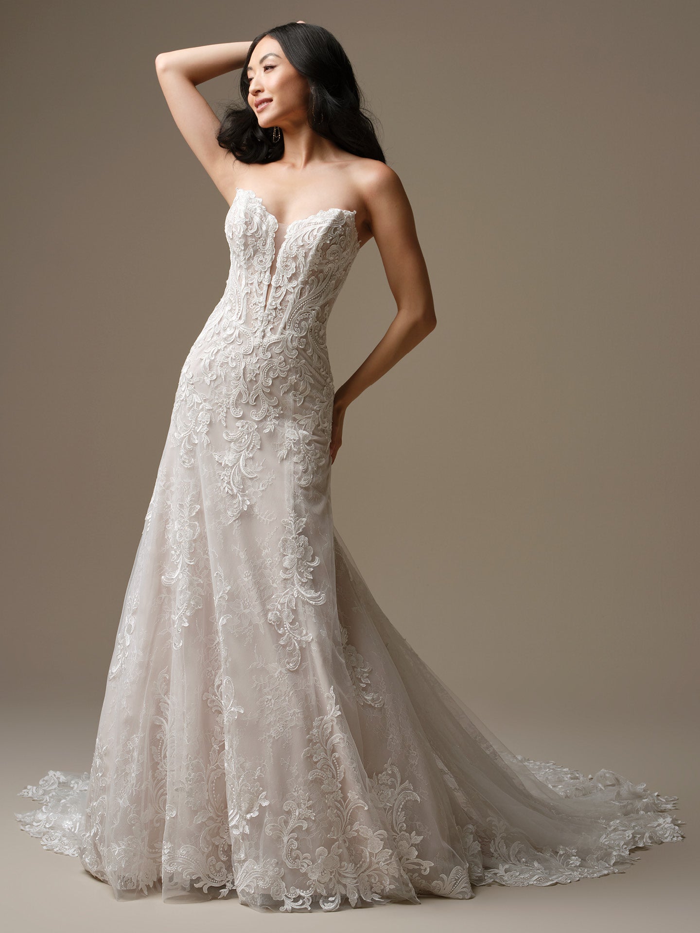 Woman wearing Farrah by Maggie Sottero - Sequin Lace A-Line Wedding Dress with Plunging Neckline against a neutral background