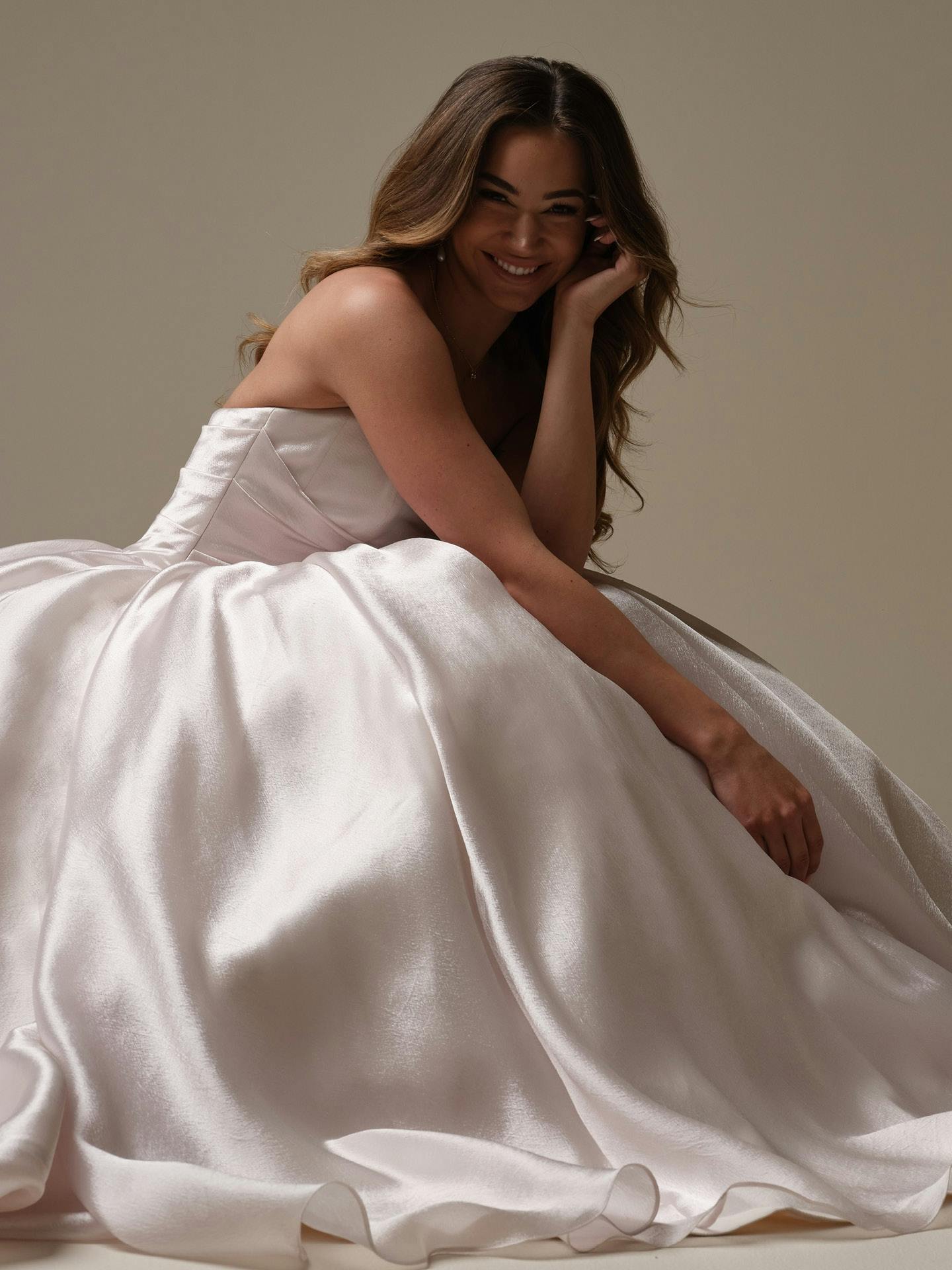 Woman in Paris by Maggie Sottero - a white dress sitting on a neutral background