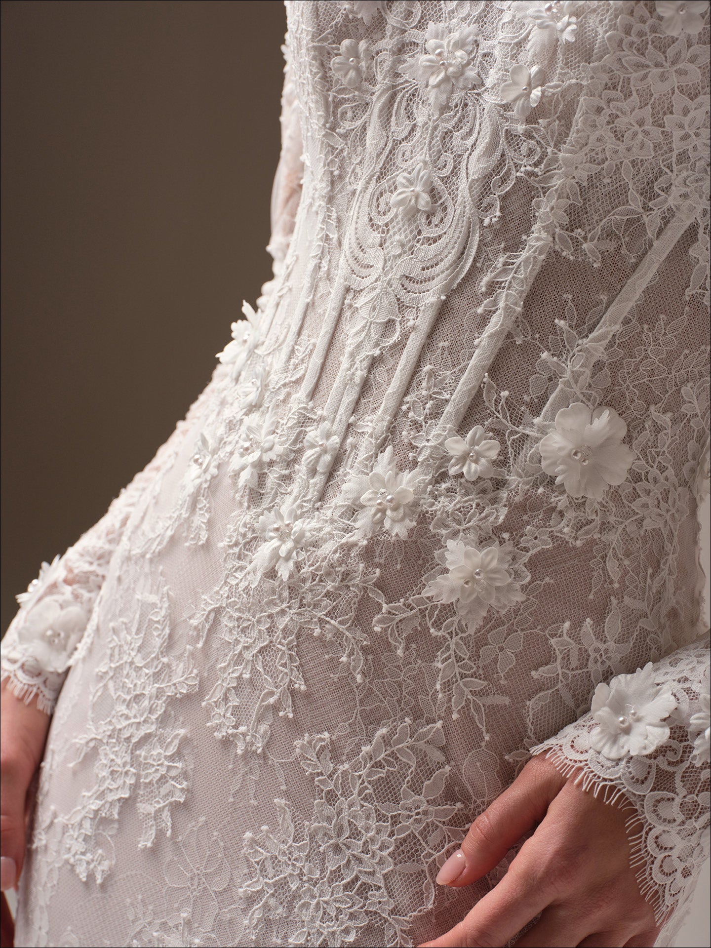 Close-up of Takera by Maggie Sottero - 3D Floral Lace Mermaid Wedding Dress with Illusion Detailing with intricate detailing