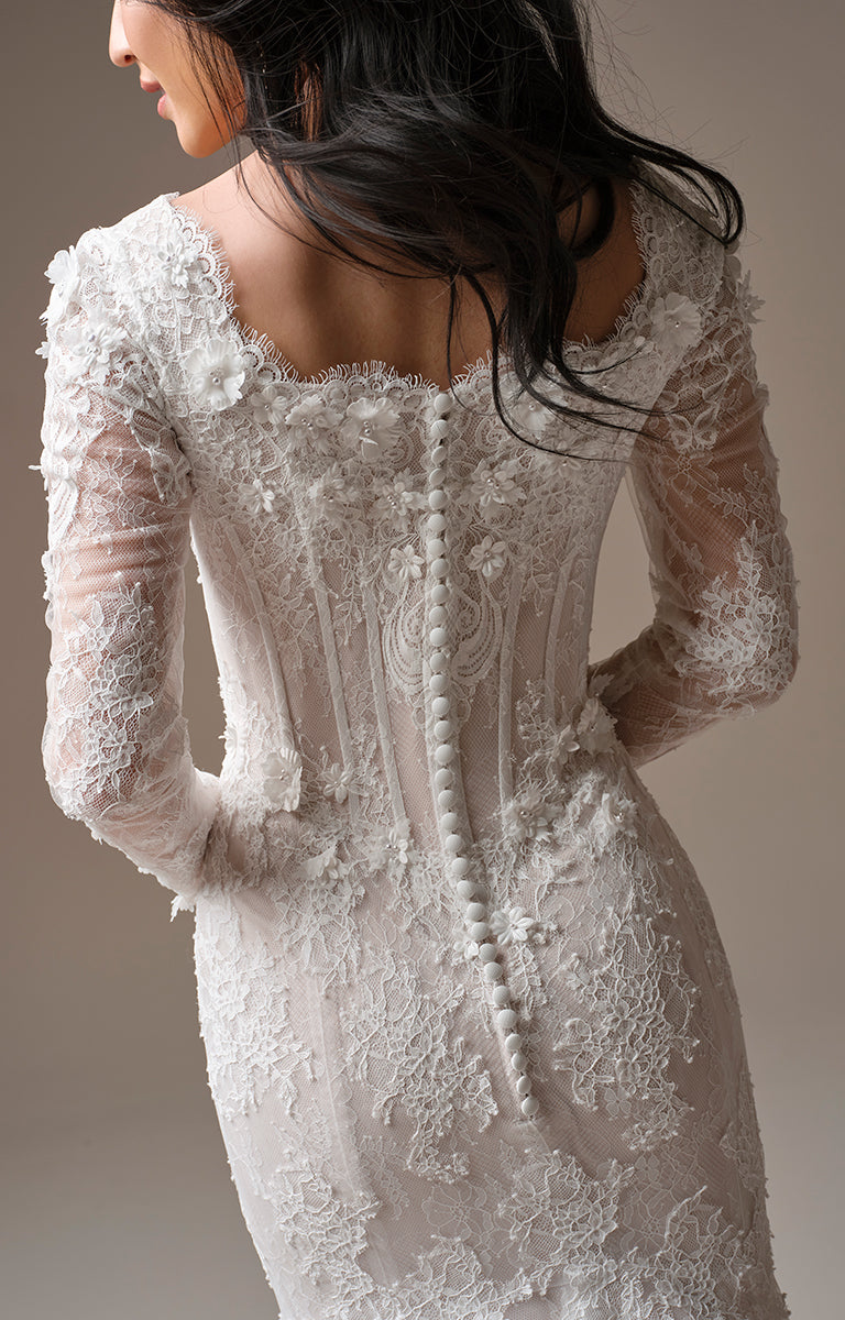 Takera Leigh by Maggie Sottero - Modest Fit-and-Flare Lace Wedding Dress with long Illusion Sleeves and intricate detailing on a neutral background