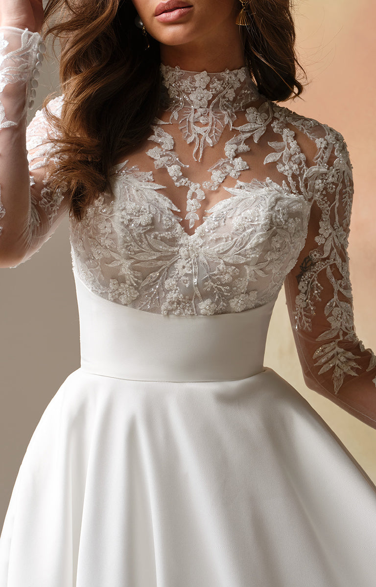 Trinity by Maggie Sottero - Regal Lace Bodice Mock-Neck A-Line Wedding Dress with lace top and long sleeves on a neutral background