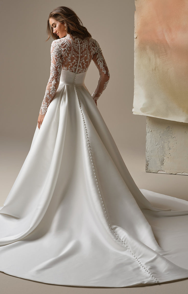 Trinity by Maggie Sottero - Regal Lace Bodice Mock-Neck A-Line Wedding Dress with lace sleeves on a neutral background