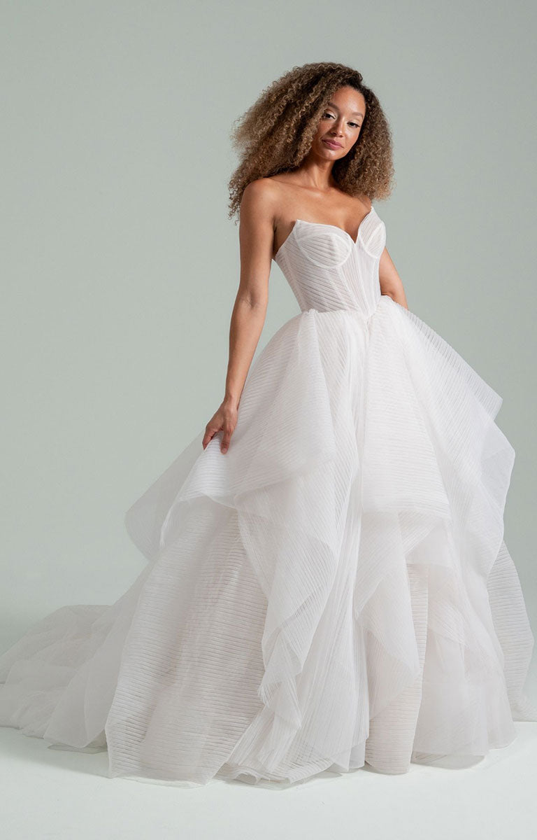 Woman wearing Once I Was a Swan by Hayley Paige - Layered Tulle Ballgown Wedding Dress with Corset Bodice on a light gray background