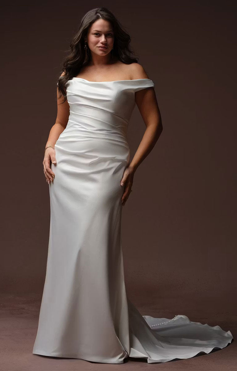 Clementine by Rebecca Ingram - Sculpted Fit-and-Flare Satin Wedding Dress with Draped Off-the-Shoulder Sleeves worn by a model against a dark brown studio backdrop.