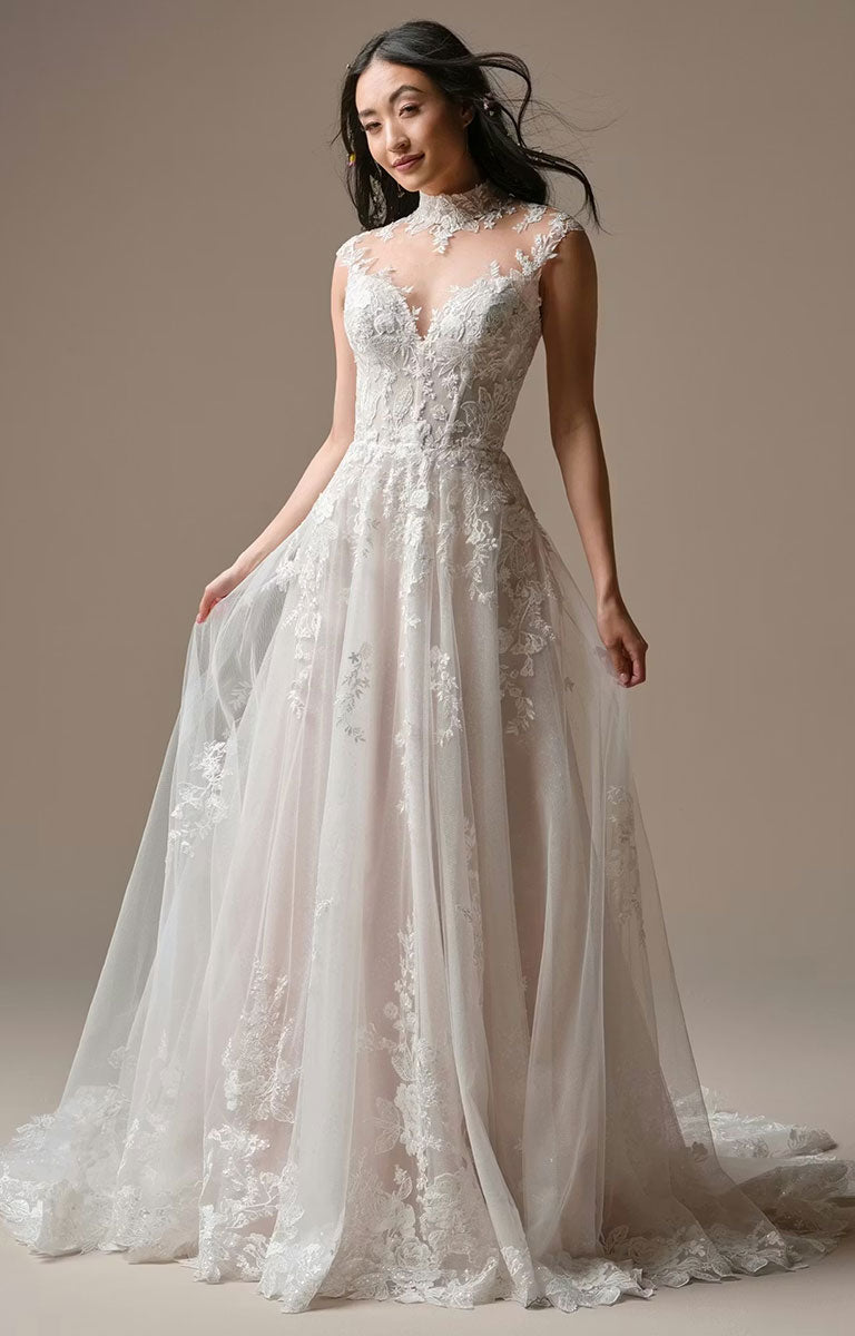 Woman wearing Cody by Rebecca Ingram - Illusion Neck Sequin Lace A-Line Wedding Dress against a neutral background