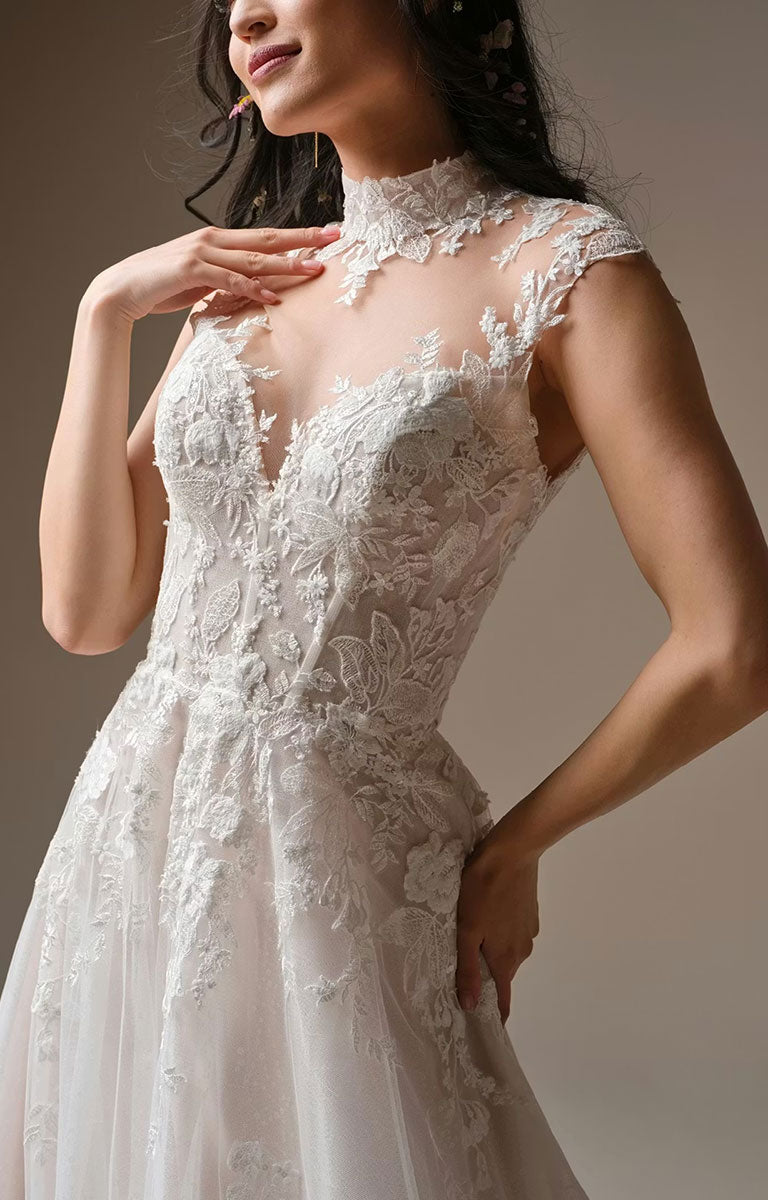 Woman wearing Cody by Rebecca Ingram - Illusion Neck Sequin Lace A-Line Wedding Dress against a neutral background