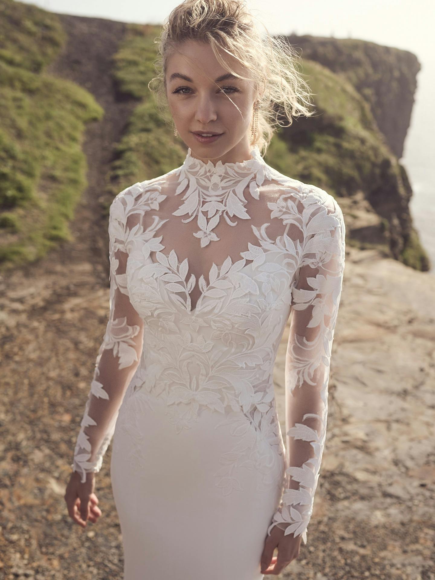 Woman wearing a white lace wedding dress in a natural setting