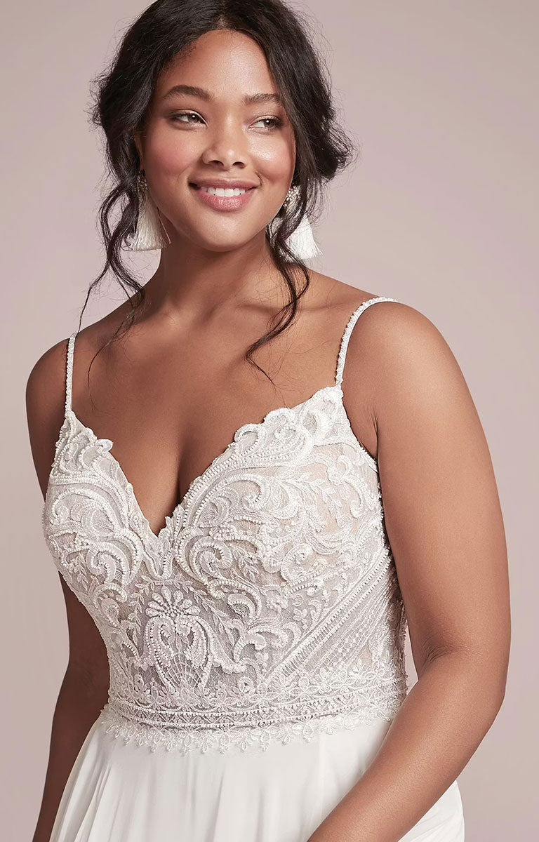 Woman wearing Lorraine by Rebecca Ingram - Beaded Chiffon Sheath Wedding Dress with V-Neckline and Split against a neutral background