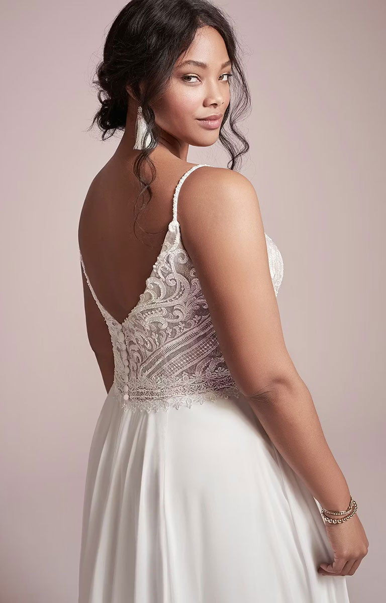 Woman wearing Lorraine by Rebecca Ingram - Beaded Chiffon Sheath Wedding Dress with V-Neckline and Split with a beige background