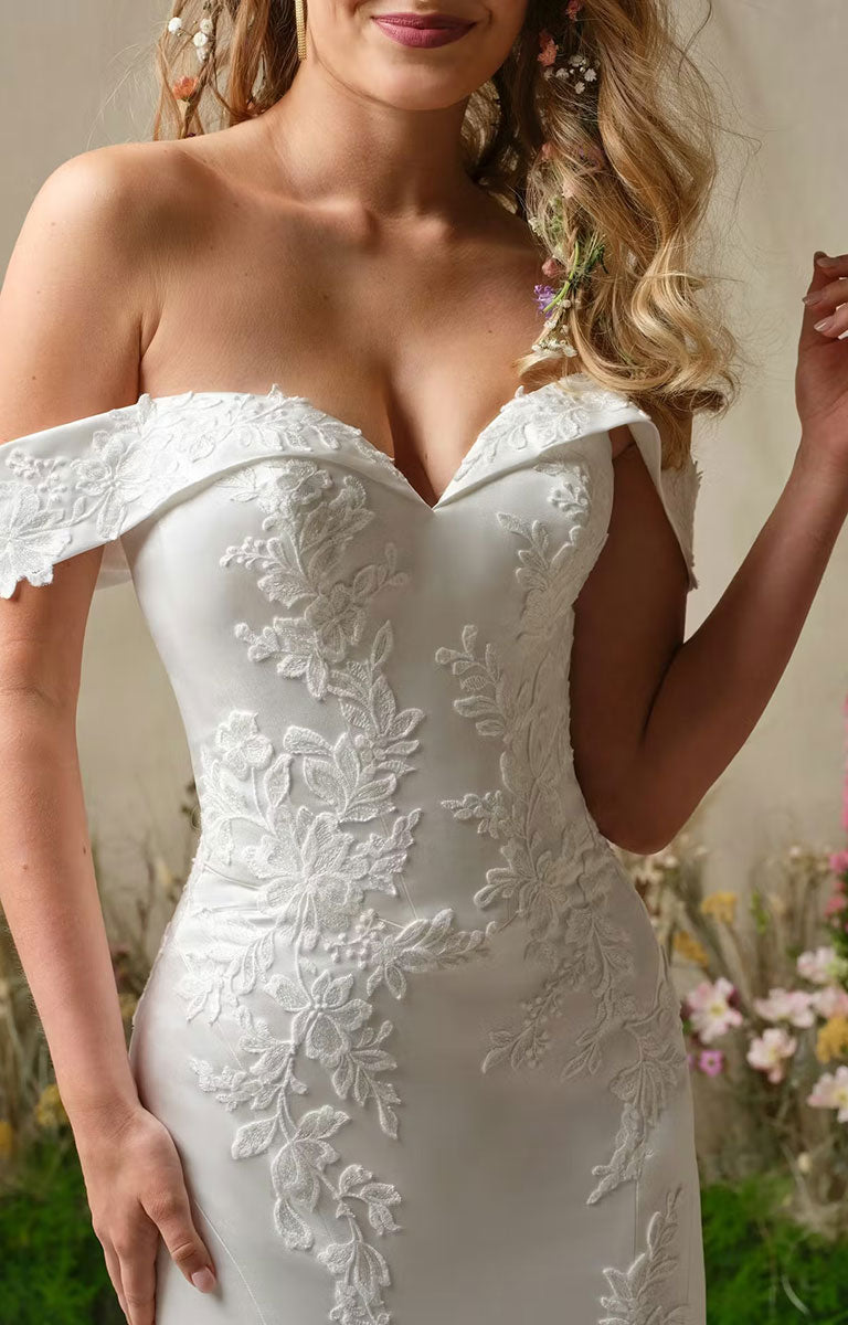 Miley by Rebecca Ingram - Off-the-Shoulder Fit-and-Flare Wedding Dress with Sequined Lace Accents worn by a model with a blurred floral background