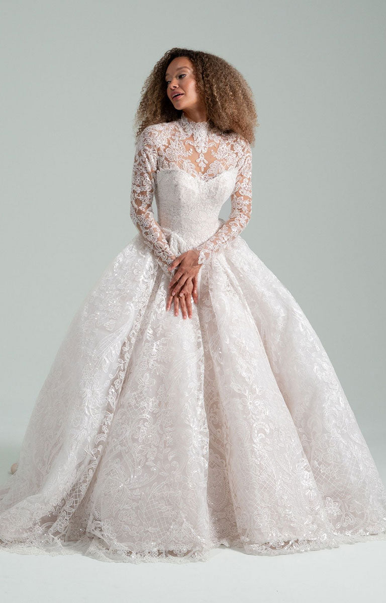 Woman wearing She Who Hung the Moon by Hayley Paige - Lace Ballgown Wedding Dress with Detachable Bolero against a light gray background