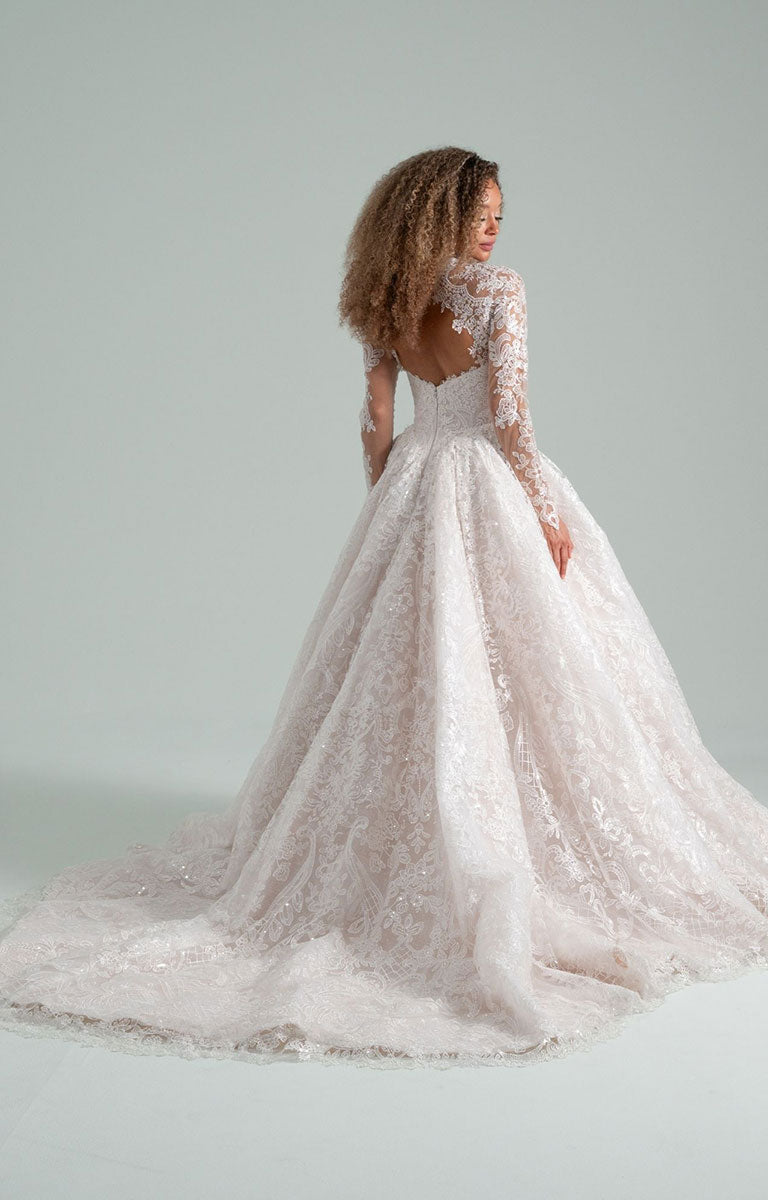 Woman wearing She Who Hung the Moon by Hayley Paige - Lace Ballgown Wedding Dress with Detachable Bolero with long sleeves on a plain background