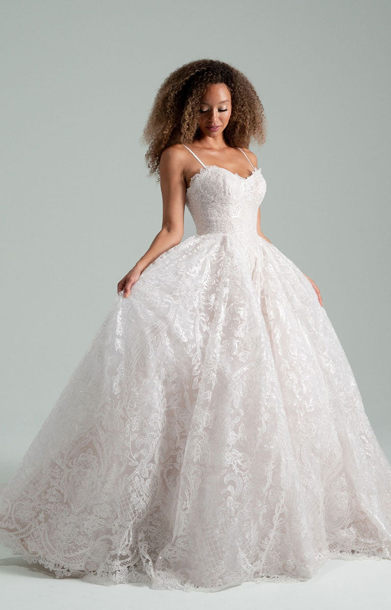 Woman wearing She Who Hung the Moon by Hayley Paige - Lace Ballgown Wedding Dress with Detachable Bolero against a gray background