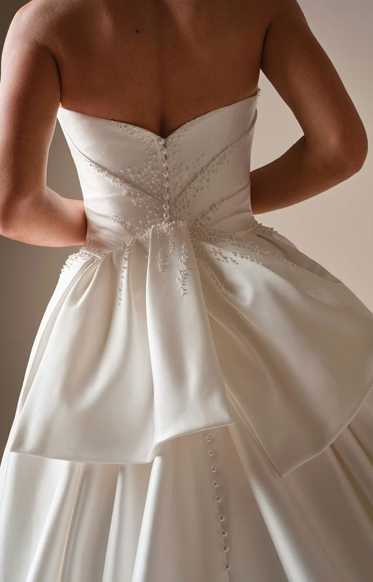 Kincaid by Sottero and Midgley - Ruched Satin Ballgown Wedding Dress with Pearl Details and Cat-Eye Neckline with intricate detailing on a neutral background