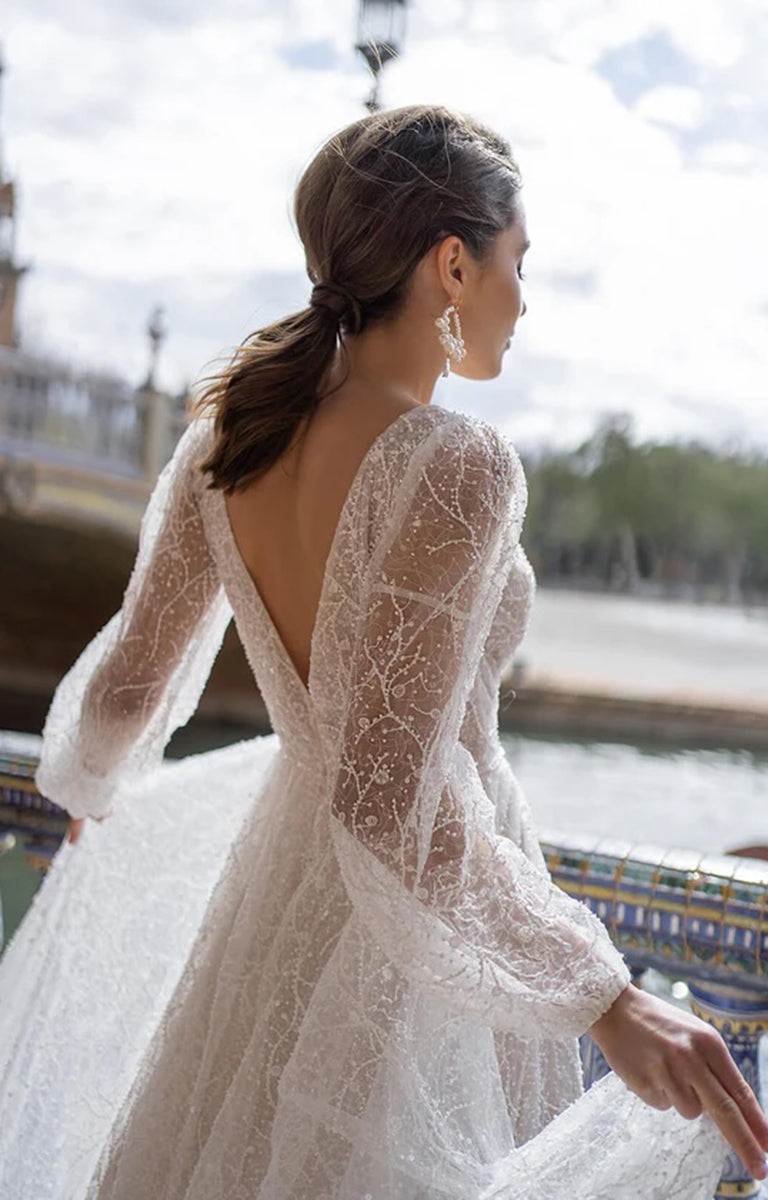 Woman in a lace wedding dress with a scenic background