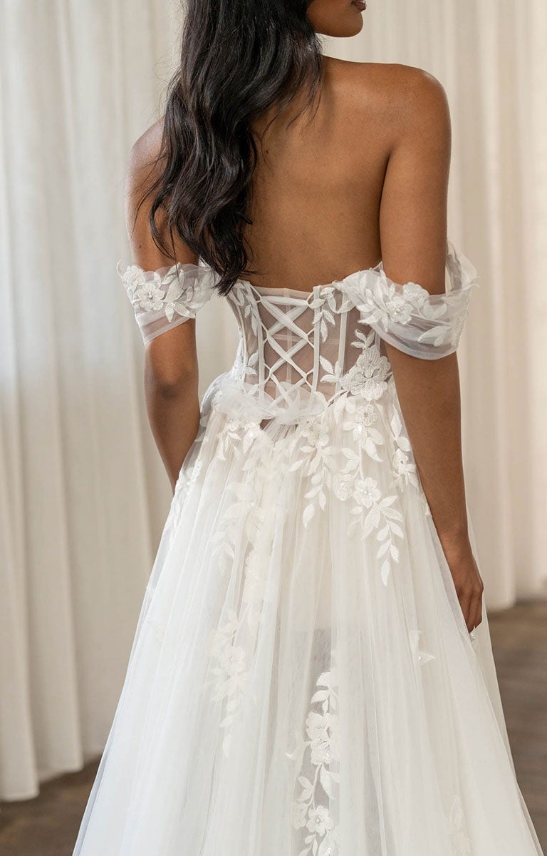 Twyla by Madi Lane, a White lace wedding dress with intricate back design against a neutral background