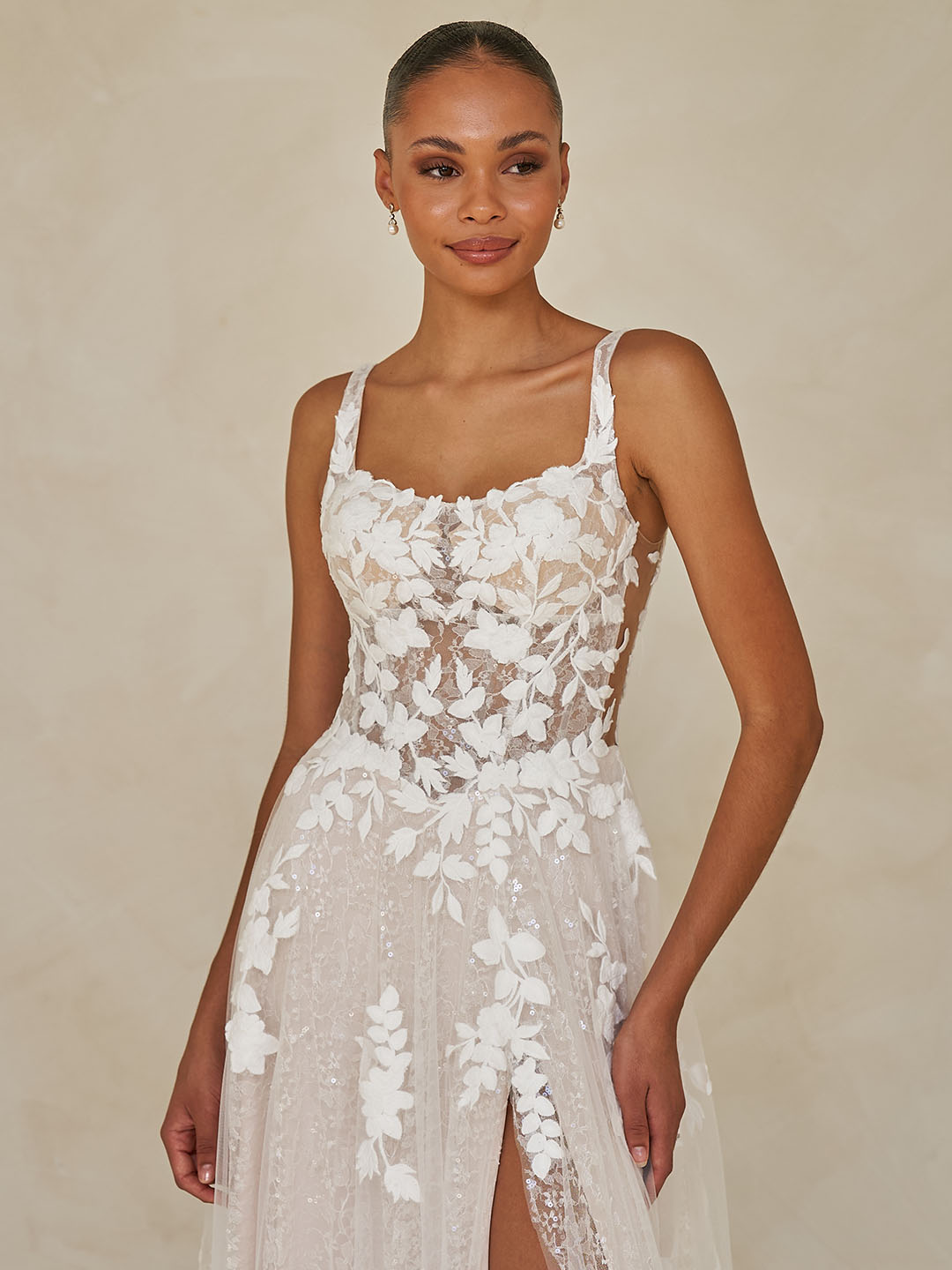 Woman wearing Wimmer by Madi Lane, a white lace dress against a beige background