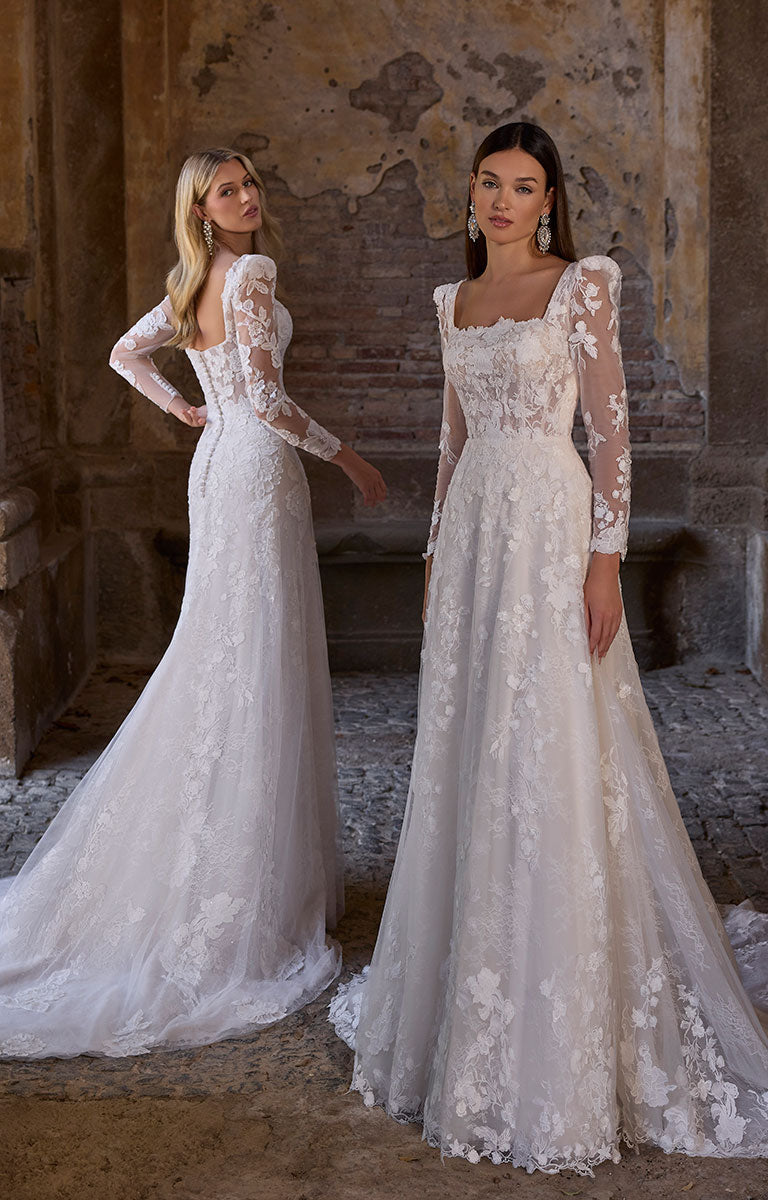 Two women wearing 63273 Apollonia by Veni Infantino - Floral Lace A-Line Wedding Dress with Square Neckline and Puff Sleeves in a rustic setting.