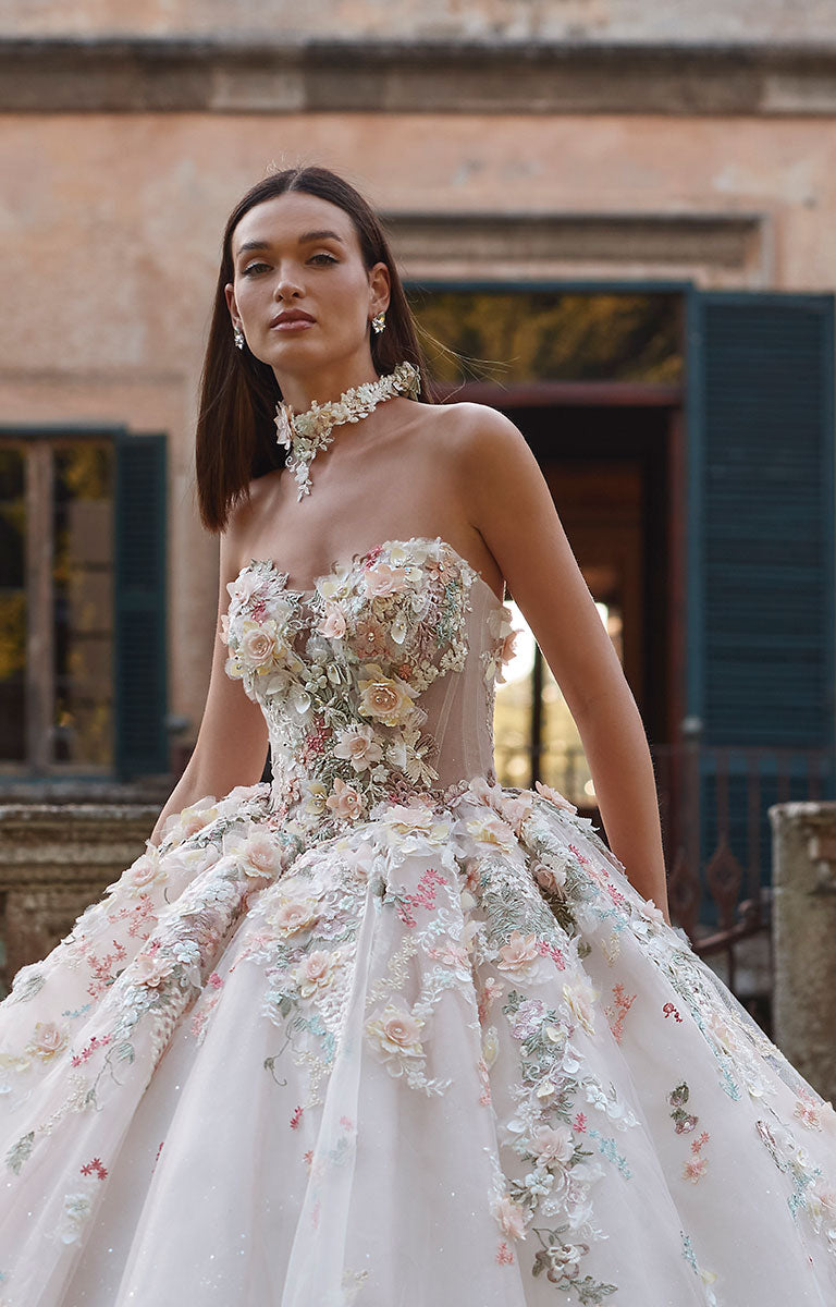 Woman wearing 63201A Aurora by Veni Infantino - Strapless Ball Gown Wedding Dress with 3D Floral Appliqués in an outdoor setting