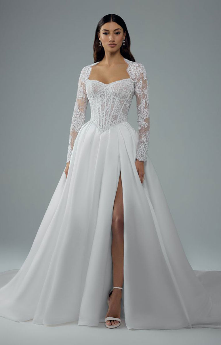 Bree Y3221 by Sophia Tolli - Corset Ball Gown Wedding Dress with Satin Skirt and Detachable Lace Jacket with a lace corset bodice, long lace sleeves, sweetheart neckline, and a high thigh slit, shown on a model against a gray studio background.